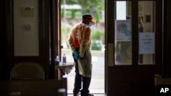 Volunteer Danny McCall Sr., waits for patients at the door of a COVID-19 vaccination clinic set up at Bethel AME Church as part of an effort to make testing and vaccines more available to an underserved community, Sept. 24, 2021, in Providence, R.I.