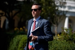 White House deputy press secretary Judd Deere waits for the arrival of President Donald Trump to the White House, Friday, Oct. 4, 2019, in Washington. (AP Photo/Evan Vucci)