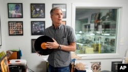 Mark Michaels, CEO and chairman of United Record Pressing, holds a vinyl record in his office July 11, 2024, in Nashville, Tenn. 