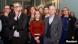 The Independence Party members and supporters react as they watch the first results of the snap parliamentary election in Reykjavik, Iceland, Oct. 28, 2017. The party won 26 percent of the vote, down 3 percentage points from last year.