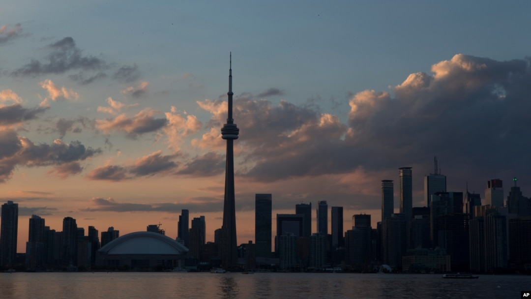 The sun sets over the Toronto skyline during the opening ceremony for the Pan Am Games, July 10, 2015. 