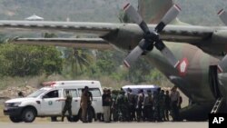 FILE - A coffin containing the body of one of the victims of a military helicopter crash in Poso, Central Sulawesi, is loaded into a cargo plane to be transported to Jakarta at the airport in the provincial capital of Palu, Indonesia, March 21, 2016.