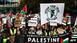 Protesters gather with placards and flags for the 'National March For Palestine' in central London on November 11, 2023, calling for a ceasefire in the conflict between Israel and Hamas.