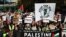 Protesters gather with placards and flags for the 'National March For Palestine' in central London on November 11, 2023, calling for a ceasefire in the conflict between Israel and Hamas.