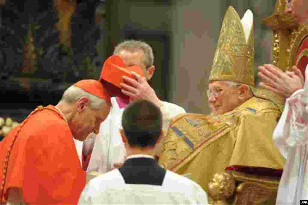 In this picture made available Monday, Nov. 22, 2010 by the Vatican newspaper Osservatore Romano, Newly-elevated US Cardinal Donald W. Wuerl, left, receives the red three-cornered biretta hat by Pope Benedict XVI during a consistory inside St. Peter's Bas