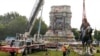 Crews remove a statue of Confederate General Robert E. Lee in Richmond, Virginia, September 8, 2021. (Steve Helber/Pool via REUTERS)