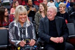 FILE - Phil Knight, right, and Penny Knight attend an NCAA college basketball game in the Phil Knight Invitational tournament in Portland, Ore., Nov. 26, 2017.