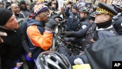 FILE - Protesters confront Chicago police during a march against police violence in Chicago, Illinois, Dec. 24, 2015.