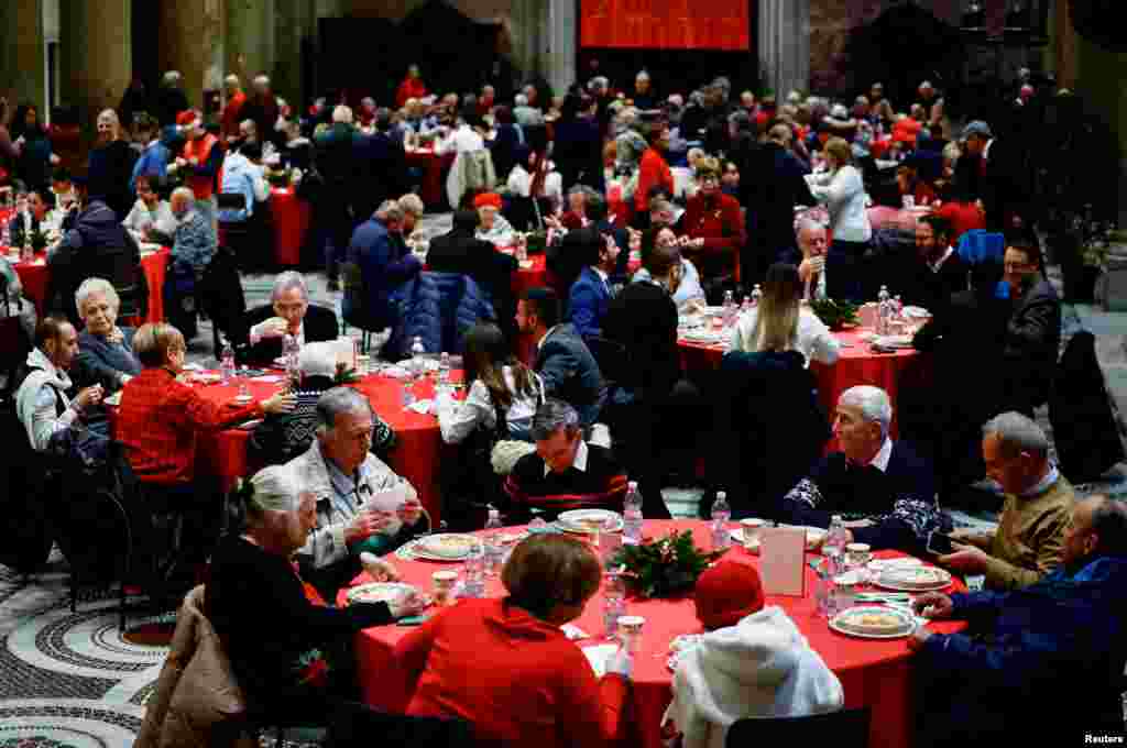 People attend the traditional Christmas lunch for the needy and poor organized by Christian charity Community of Sant&#39;Egidio in the Basilica of Santa Maria in Trastevere, in Rome, Italy, Dec. 25, 2024.