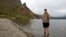In this Saturday, Aug. 18, 2018, photo, Sinead of Australia stands in the cool water of Lake Chon during a hike arranged by Roger Shepherd of Hike Korea on Mount Paektu in North Korea.