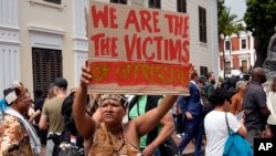 Khoisan protesters protest during the visit of King Willem Alexander and Queen Maxima of the Netherlands at the Slave Lodge in Cape Town, South Africa, Friday, Oct. 20, 2023.