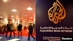 FILE - The logo of Al Jazeera Media Network is seen at the MIPTV, the International Television Programs Market, event in Cannes.