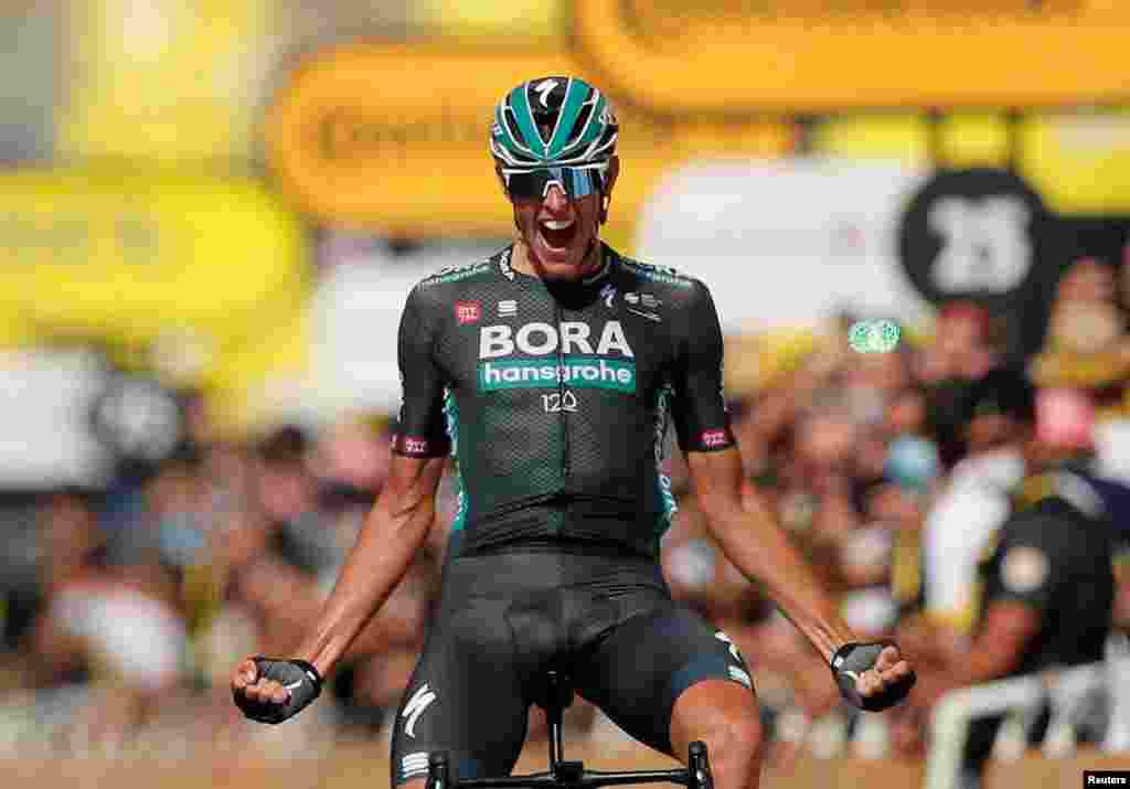 German Nils Politt celebrates as he crosses the finish line to win stage 12 of the Tour de France cycling race over 159.4 kilometers (99 miles) from Saint-Paul-Trois-Chateaux to Nimes, France.