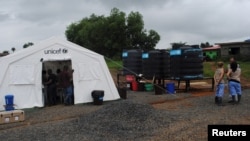 Health workers gather at a clinic in Nedowein, Liberia, July 10, 2015. 