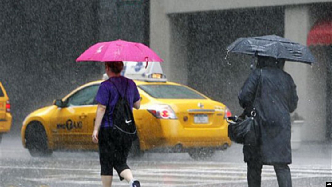 Pedestrians walk in a heavy downpour on Lexington Avenue in New York City as Hurricane Irene moves up the East Coast, August. 27, 2011