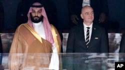 FILE - Saudi Arabia Crown Prince Mohammed bin Salman, left, and FIFA President Gianni Infantino, stand for the anthem prior to the soccer World Cup match between Russia and Saudi Arabia at the Luzhniki stadium in Moscow, on June 14, 2018. 