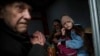 Hanna, 12, and members of her family sit inside a van during an evacuation from Pokrovsk, Ukraine, Dec. 21, 2024, as Russian forces close in on the city.