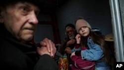 Hanna, 12, and members of her family sit inside a van during an evacuation from Pokrovsk, Ukraine, Dec. 21, 2024, as Russian forces close in on the city.