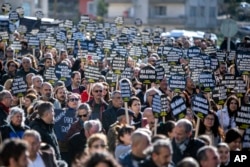 People march as they mark the anniversary of the 2023 earthquake that killed some 56,000 people in Turkey and Syria, in Antakya, Turkey, on Feb. 6, 2024.