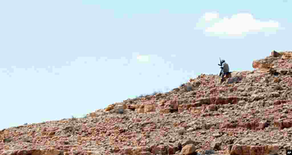 An NTC fighter searches for pro-Gadhafi snipers, Bani Walid, Libya, September 10, 2011. - E. Arrott
