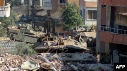 Israeli armored vehicles instrumentality     presumption   down  a obstruction  astatine  the entranceway  of the confederate  Lebanese colony   of Aitaroun connected  Jan. 29, 2025.