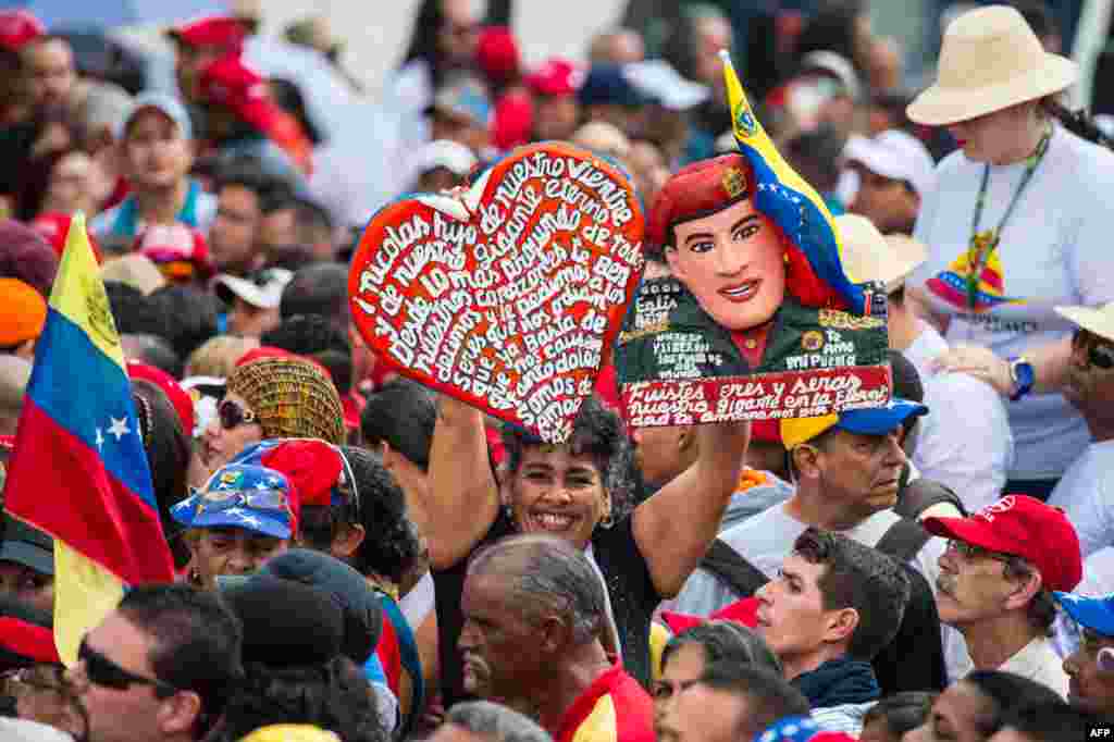Supporters of Venezuelan President Nicolas Maduro wait for him during a rally to commemorate the 57th anniversary of the end of Venezuelan dictator Marcos Perez Jimenez&#39;s regime, in Caracas.