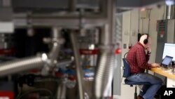 FILE - A man works in the quantum computing lab at the IBM Thomas J. Watson Research Center in Yorktown Heights, N.Y. , Feb. 27, 2018.