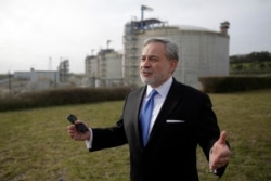 FILE - U.S. Secretary of Energy Dan Brouillette gestures during an interview at the LNG terminal of the deepwater port of Sines after visiting the port, in Sines, southern Portugal, Feb. 12, 2020.