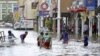 Children play in a flooded street in downtown Kota Bharu, Kelantan, Malaysia.