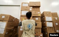 FILE - A World Food Program worker arranges relief packages at a warehouse at the Bole International Airport in Addis Ababa, Ethiopia, April 14, 2020.