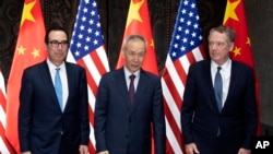 FILE - Chinese Vice Premier Liu He, center, poses with U.S. Trade Representative Robert Lighthizer, right, and Treasury Secretary Steven Mnuchin, for photos before holding talks at the Xijiao Conference Center in Shanghai, July 31, 2019.