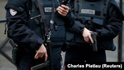 FILE - French police stand guard in Paris, France, Jan. 7, 2016. 