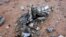 FILE - Debris is seen at the crash site of Air Algerie flight AH5017 near the northern Mali town of Gossi, July 24, 2014. Poor weather was the most likely cause of the crash of an Air Algerie flight in the West African state of Mali, July 24, 2014.