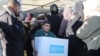 FILE - A Palestinian boy carries an aid box provided by UNRWA, following a ceasefire between Israel and Hamas, in Khan Younis in the southern Gaza Strip, Jan. 21, 2025.