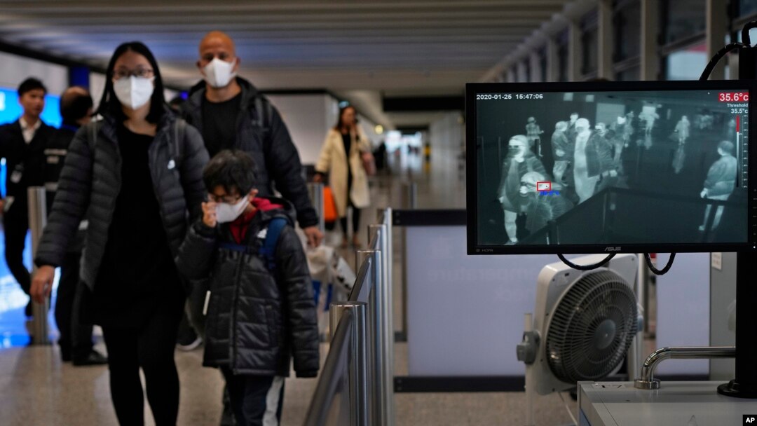 Health surveillance officer use temperature scanner to monitor passengers arriving at Hong Kong International Airport in Hong Kong, Jan. 25, 2020.