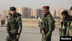 FILE - Members of the Kurdish-led Syrian Democratic Forces stand along a street, after rebels seized the capital and ousted Syria's Bashar al-Assad, in Hasakah, Syria, Dec. 11, 2024.