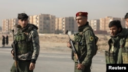 Members of Kurdish-led Syrian Democratic Forces (SDF) stand along a street, after rebels seized the capital and ousted Syria's Bashar al-Assad, in Hasakah, Syria, Dec. 11, 2024.