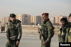 Members of Kurdish-led Syrian Democratic Forces (SDF) stand along a street, after rebels seized the capital and ousted Syria's Bashar al-Assad, in Hasakah, Syria, Dec. 11, 2024.