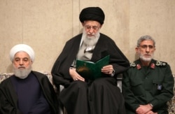 This handout picture provided by the office of Iran's Supreme Leader Ayatollah Ali Khamenei Jan. 9, 2020, shows him (C) alongside President Hassan Rouhani (L) and the newly-appointed commander of the Quds Force Esmail Qaani, in Tehran, Iran.