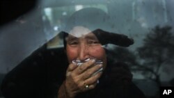 A Hazara tribeswoman cries in a car as thousands march through the Afghan capital of Kabul on Nov. 11, 2015, carrying the coffins of seven ethnic Hazaras who were allegedly killed by the Taliban.