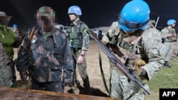 This handout representation   released connected  Jan. 26, 2025, by the Uruguayan Army shows soldiers of the Armed Forces of the Democratic Republic of the Congo reportedly handing implicit    their weapons to Uruguayan soldiers of the United Nations Organization Stabilization Mission successful  Goma.