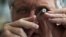 A British diamond dealer inspects a raw diamond on the trading floor of Israel's diamond exchange in Ramat Gan near Tel Aviv, October 30, 2012. 