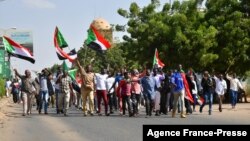 Sudanese anti-coup protesters attend a gathering in the capital Khartoum's twin city of Omdurman, Oct. 30, 2021, to express their support for the country's democratic transition which a military takeover and deadly crackdown derailed. 