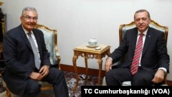 Turkish President Recep Tayyip Erdogan meets the former leader of the Republican People's Party, Deniz Baykal, at the presidential palace in Ankara, June 10, 2015.