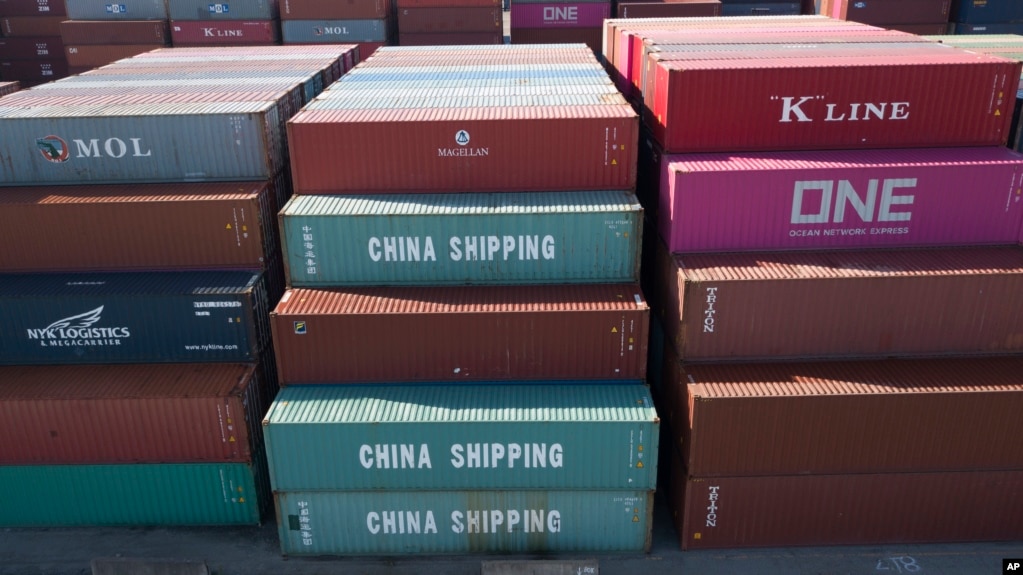 FILE - China Shipping Company containers are stacked at the Virginia International's terminal in Portsmouth, Va., May 10, 2019.