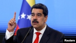 FILE - Venezuelan President Nicolas Maduro speaks during a news conference in Caracas, Dec. 8, 2020.