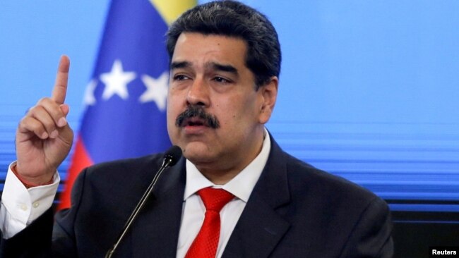 FILE - Venezuelan President Nicolas Maduro speaks during a news conference in Caracas, Dec. 8, 2020.