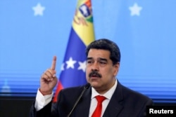 FILE - Venezuelan President Nicolas Maduro speaks during a news conference in Caracas, Dec. 8, 2020.