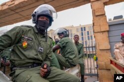 FILE - Nigerien police officers sit outside the customs offices in Niamey, Niger, on Aug. 21, 2023. .