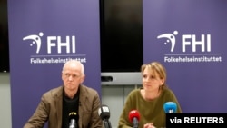 Officials in Norway's Public Health Agency, Geir Bukholm and Line Vold, speak during a news conference about the spread of the coronavirus in their country, at the Institute of Public Health in Oslo, Norway, Feb. 26, 2020. 